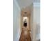 Long hallway with light wood flooring and neutral walls at 5401 Stevens Mill Rd, Matthews, NC 28104