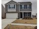 Two-story house with gray siding, brick accents, and a two-car garage at 110 Hillspring Ln, Troutman, NC 28166