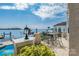 Lake view patio with seating area and lush greenery at 3446 Governors Island Dr, Denver, NC 28037