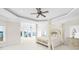 Main bedroom with large bed, lake view, and access to balcony at 3446 Governors Island Dr, Denver, NC 28037