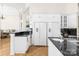 Modern kitchen with white cabinets, granite counters, and stainless steel appliances at 3446 Governors Island Dr, Denver, NC 28037