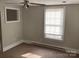 Bright bedroom with carpet flooring, neutral walls, and a window at 105 S Inman Ave, Bessemer City, NC 28016