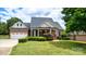 Brick ranch home with a two-car garage and manicured lawn at 4008 Broadwing Ct, Gastonia, NC 28056