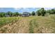 Large backyard with corn stalks and distant homes at 2005 Germany Dr, Dallas, NC 28034
