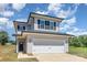 Two-story house with white siding, black accents and a two-car garage at 2005 Germany Dr, Dallas, NC 28034