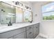 Double vanity bathroom with a large mirror and modern light fixtures at 2005 Germany Dr, Dallas, NC 28034