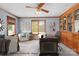 Virtually staged home office features built-in shelving and hardwood floors at 4299 Randleman Rd, Iron Station, NC 28080