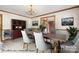 Virtually staged dining room with elegant chandelier and hardwood floors at 4299 Randleman Rd, Iron Station, NC 28080