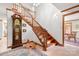 Grand entryway with wooden staircase, grandfather clock, and tile floors at 4299 Randleman Rd, Iron Station, NC 28080