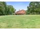 Large backyard with green lawn and mature trees at 4299 Randleman Rd, Iron Station, NC 28080