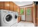 Laundry room with washer, dryer, cabinets, and exterior access at 4299 Randleman Rd, Iron Station, NC 28080