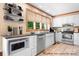 Virtually staged kitchen with white cabinets and stainless steel appliances at 4299 Randleman Rd, Iron Station, NC 28080