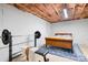 Basement bedroom with weight bench and full-size bed at 4299 Randleman Rd, Iron Station, NC 28080
