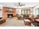 Cozy Gathering room with brick fireplace and leather furniture at 4299 Randleman Rd, Iron Station, NC 28080