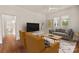 Bright living room with hardwood floors, neutral walls, and a view into the kitchen at 1107 E 36Th St, Charlotte, NC 28205