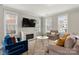 Living room with fireplace, neutral-toned furniture, and large TV at 2220 Camalier Ln, Charlotte, NC 28273