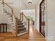 Bright entryway with hardwood floors and staircase leading upstairs at 7239 Sheffingdell Dr, Charlotte, NC 28226