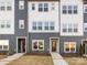 Three-story townhome with gray and white siding and walkway at 1530 Levy Way, Charlotte, NC 28205