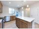 Modern kitchen with island, stainless steel appliances, and light wood cabinets at 1530 Levy Way, Charlotte, NC 28205
