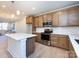 Modern kitchen with island, stainless steel appliances, and light wood cabinets at 1530 Levy Way, Charlotte, NC 28205
