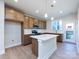 Modern kitchen with an island, stainless steel appliances, and light wood cabinets at 1530 Levy Way, Charlotte, NC 28205