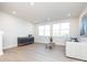 Bright living room with large windows, hardwood floors, and a comfy sofa at 1530 Levy Way, Charlotte, NC 28205