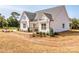 Side view of the white farmhouse exterior at 608 Plowshare Way, Clover, SC 29710