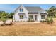 White farmhouse exterior with landscaping and driveway at 608 Plowshare Way, Clover, SC 29710