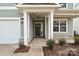 Covered front porch entry with gray door and stone accents at 2351 Trundle Dr # Cwo0161, Gastonia, NC 28054