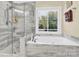 Spa-like bathroom with soaking tub and glass shower enclosure at 8534 Headford Rd, Charlotte, NC 28277