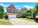 Brick two-story house with a large driveway and mature trees at 8534 Headford Rd, Charlotte, NC 28277