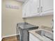 Laundry room with modern washer, dryer, and cabinets at 8534 Headford Rd, Charlotte, NC 28277
