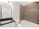 Modern bathroom with a tub, shower, and dark-colored tile at 518 Ideal Way, Charlotte, NC 28203