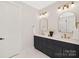 Double vanity bathroom with dark cabinetry and gold fixtures at 518 Ideal Way, Charlotte, NC 28203