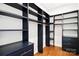 Custom walk-in closet with dark wood shelving and drawers at 518 Ideal Way, Charlotte, NC 28203