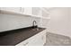 Laundry room with white cabinets, dark countertop, and a utility sink at 518 Ideal Way, Charlotte, NC 28203