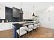 Modern kitchen with a large island, black and white color scheme, and a statement hood at 518 Ideal Way, Charlotte, NC 28203