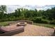 Brick paved patio with fire pit and lounge chair at 124 Rosebay Dr, Mooresville, NC 28117