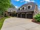 Elegant home exterior with a three-car garage and manicured landscaping at 14009 Island Dr, Huntersville, NC 28078