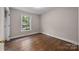 Bright bedroom with hardwood floors and a window offering natural light at 866 Concord Rd, Davidson, NC 28036