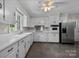 Kitchen with white cabinets, stainless steel appliances, and tile floor at 866 Concord Rd, Davidson, NC 28036