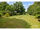 Open grassy backyard area with mature trees at 866 Concord Rd, Davidson, NC 28036