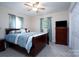 Spacious bedroom with wood furniture and a TV at 157 Woodrun Dr, Mount Gilead, NC 27306