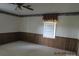 Spacious bedroom with wood paneling and ceiling fan at 115 Sunrise Cir, Shelby, NC 28150