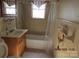 Bathroom with tub shower, vanity sink, and window at 115 Sunrise Cir, Shelby, NC 28150