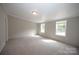 Main bedroom with neutral walls, carpet flooring, and two windows at 2574 Orchard Rd, Smyrna, SC 29743