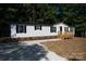Single-wide manufactured home with deck and gravel driveway at 2574 Orchard Rd, Smyrna, SC 29743