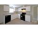 White cabinets, granite countertops, black appliances, and a window in the kitchen at 2574 Orchard Rd, Smyrna, SC 29743