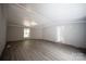 Spacious living room with grey walls, grey laminate flooring, and a window at 2574 Orchard Rd, Smyrna, SC 29743