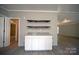 White cabinets, granite countertops, and floating shelves above white cabinets at 2574 Orchard Rd, Smyrna, SC 29743